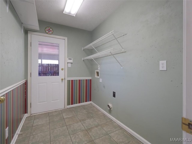 clothes washing area featuring electric dryer hookup, hookup for a washing machine, and a textured ceiling