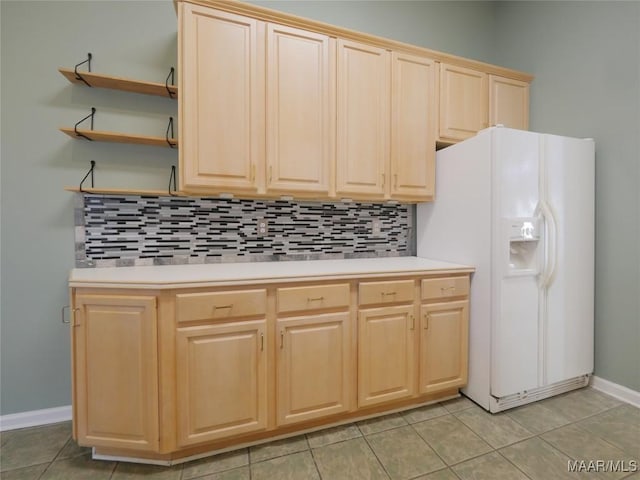 kitchen featuring backsplash, light brown cabinetry, light tile patterned flooring, and white refrigerator with ice dispenser