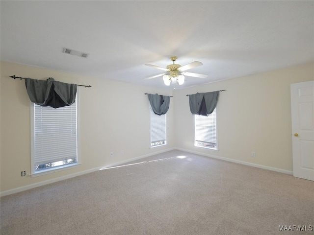 unfurnished room featuring ceiling fan and light colored carpet