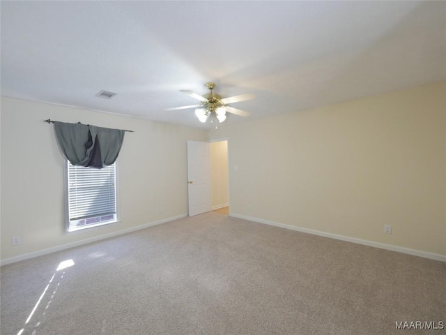 unfurnished room with ceiling fan and light carpet