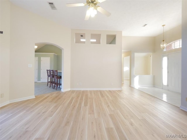 unfurnished living room with light wood-type flooring and ceiling fan