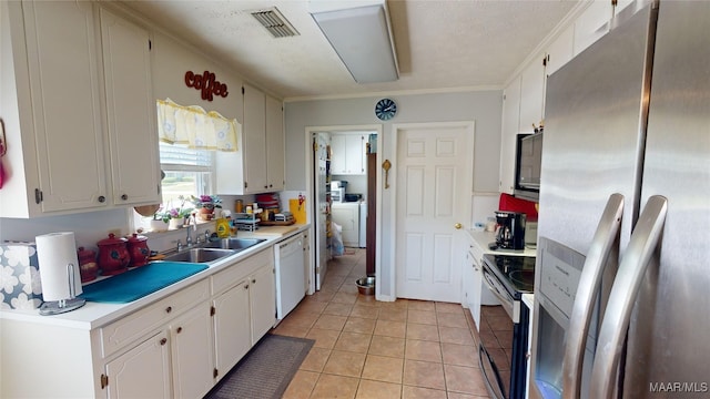 kitchen featuring light tile patterned flooring, sink, white cabinets, and stainless steel appliances