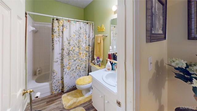 full bathroom featuring shower / bath combo, vanity, hardwood / wood-style flooring, and toilet