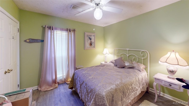 bedroom with ceiling fan and wood-type flooring