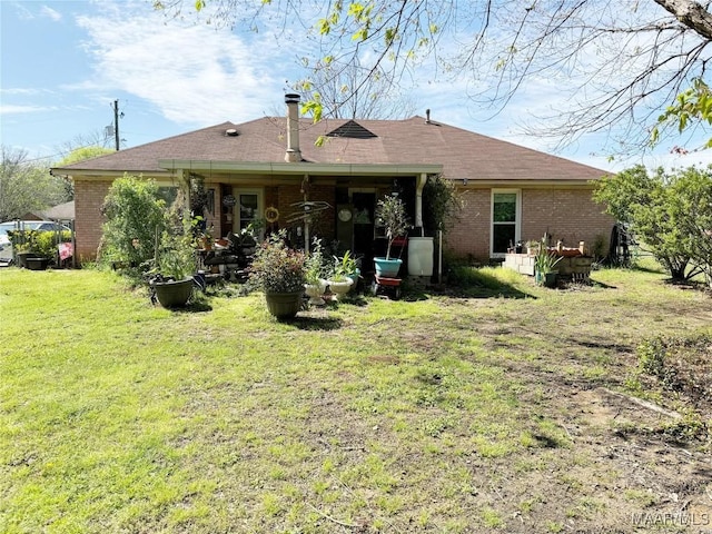 back of property featuring a lawn