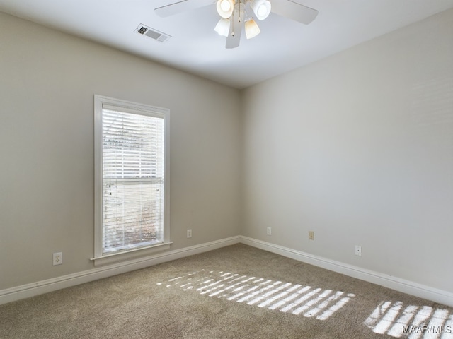 carpeted empty room featuring ceiling fan