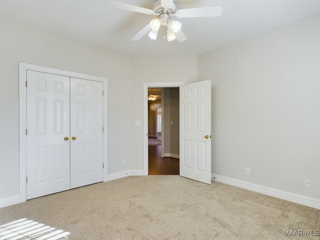 unfurnished bedroom featuring a closet, ceiling fan, and light colored carpet