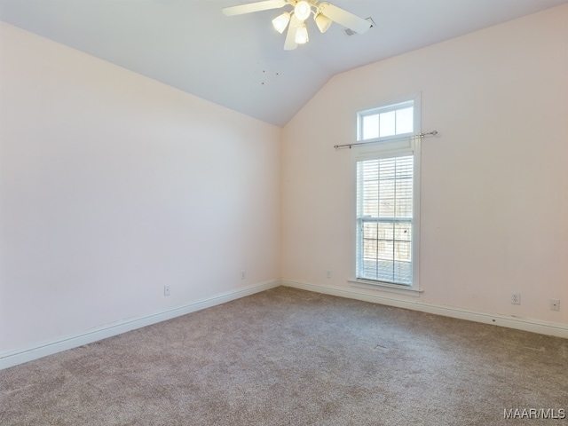 carpeted spare room with ceiling fan and lofted ceiling