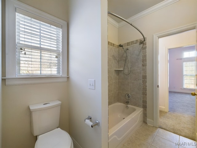 bathroom featuring crown molding, tile patterned flooring, tiled shower / bath combo, and toilet