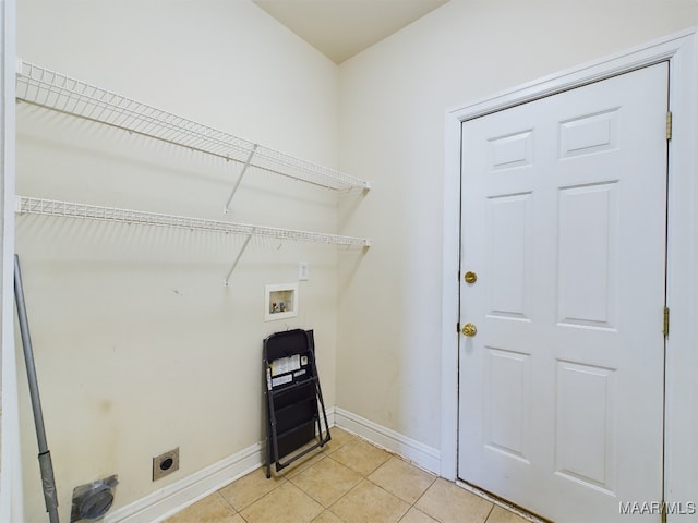 laundry room featuring electric dryer hookup, hookup for a washing machine, and light tile patterned floors