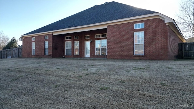 back of house with a lawn