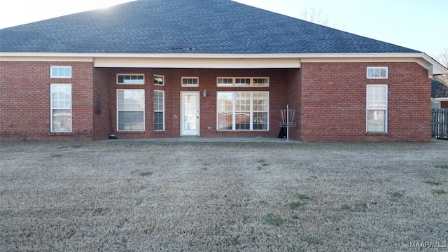 rear view of property with a lawn