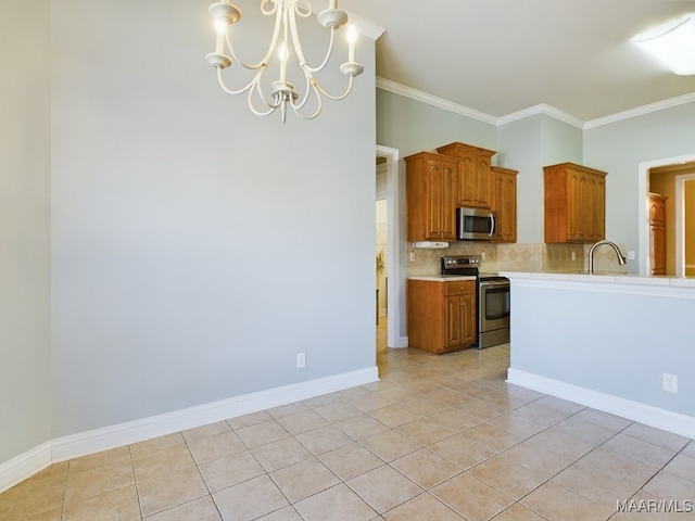 kitchen with hanging light fixtures, stainless steel appliances, a chandelier, light tile patterned floors, and ornamental molding