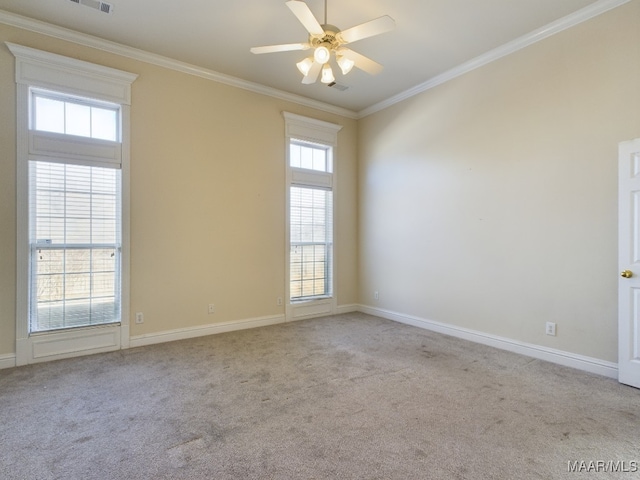 carpeted spare room with ceiling fan and crown molding