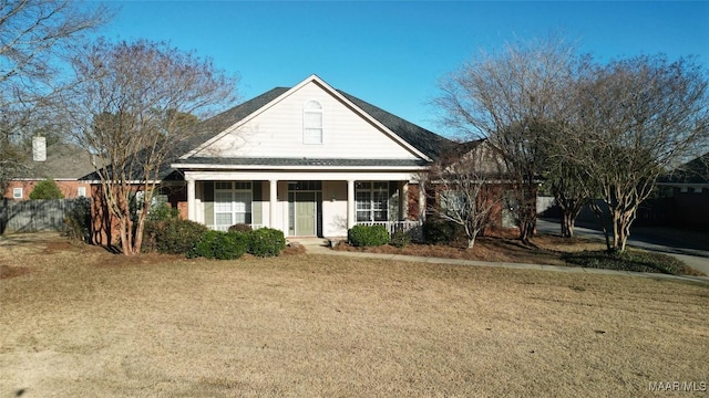 view of front of property with a porch and a front lawn