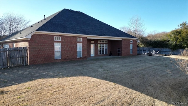 back of house with a lawn