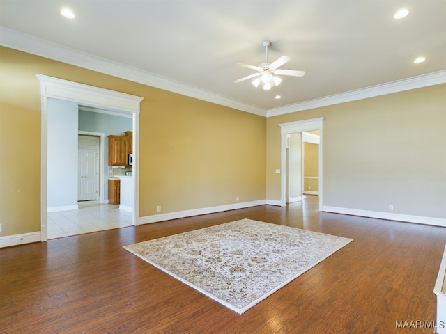 spare room featuring ceiling fan, light hardwood / wood-style flooring, and ornamental molding