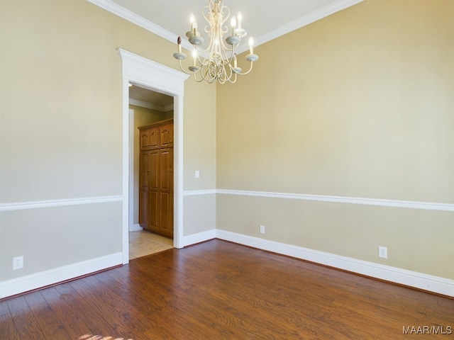 unfurnished room featuring a chandelier, hardwood / wood-style flooring, and crown molding