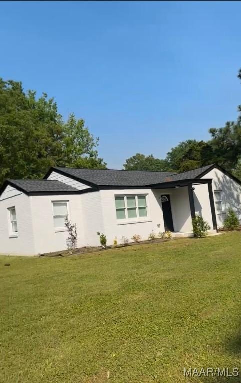 rear view of house with a lawn