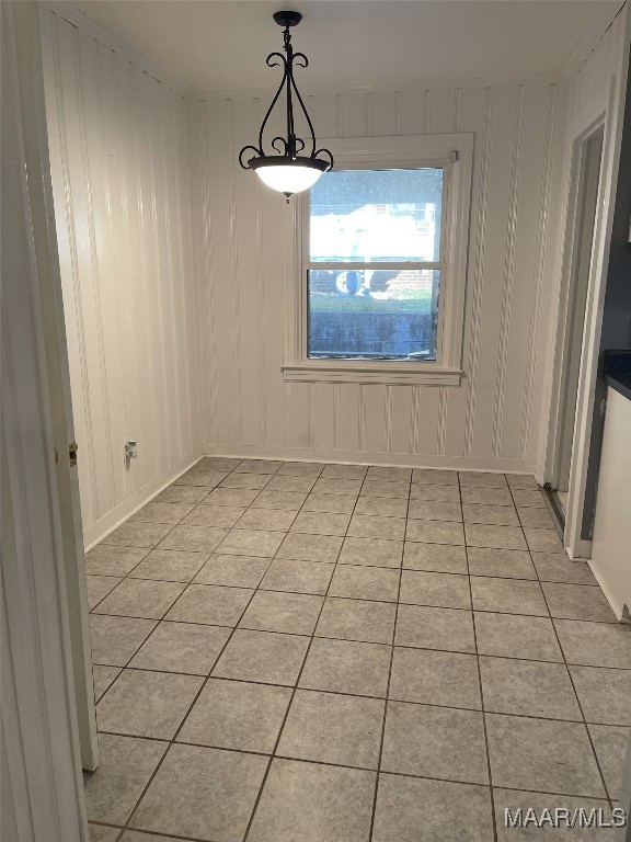 unfurnished dining area with light tile patterned flooring