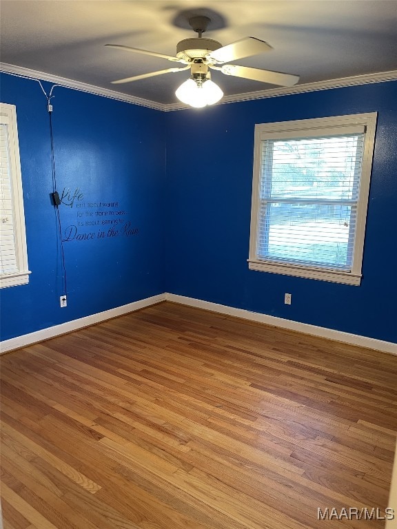 spare room with ceiling fan, wood-type flooring, and ornamental molding