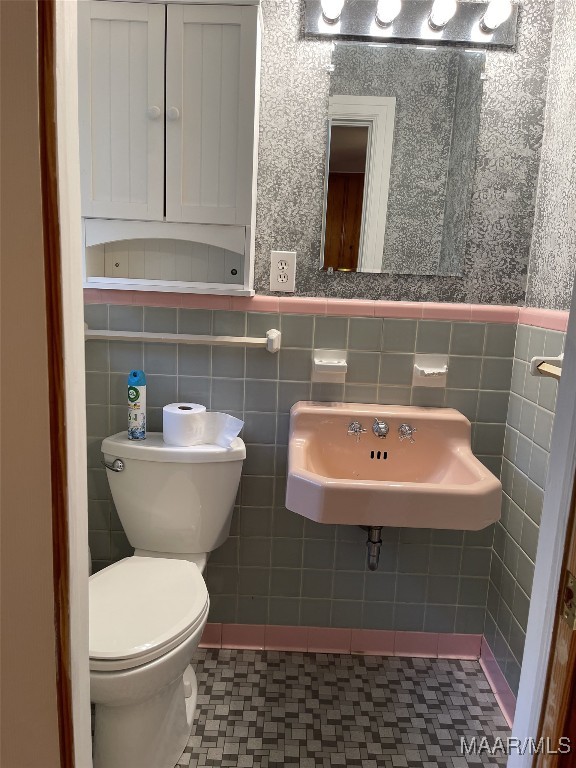 bathroom with tile patterned flooring, toilet, and sink