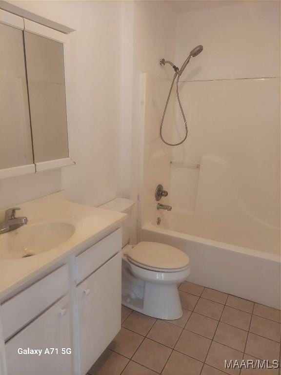 full bathroom with washtub / shower combination, vanity, tile patterned floors, and toilet