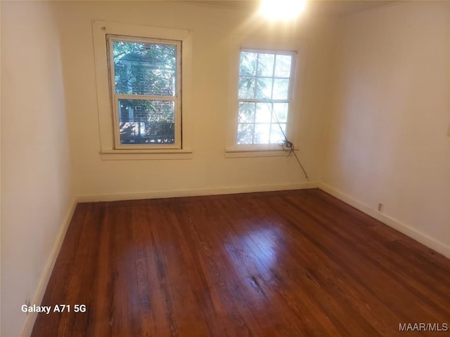 unfurnished room featuring dark hardwood / wood-style floors