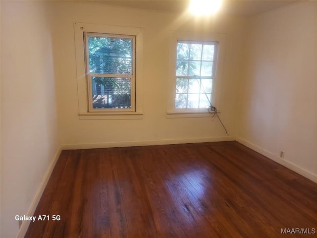 spare room featuring dark hardwood / wood-style floors