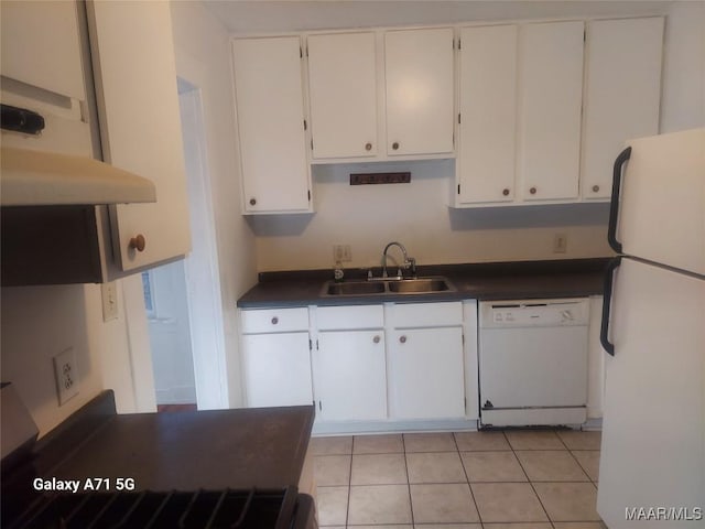 kitchen with white cabinets, white appliances, sink, and light tile patterned floors