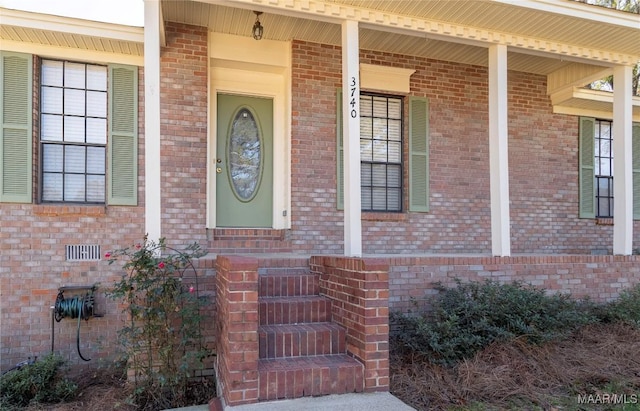 view of exterior entry with a porch