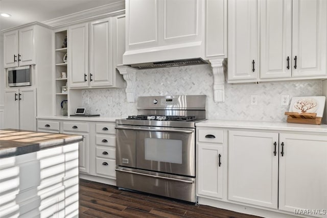 kitchen featuring white cabinetry, dark hardwood / wood-style flooring, decorative backsplash, custom range hood, and appliances with stainless steel finishes