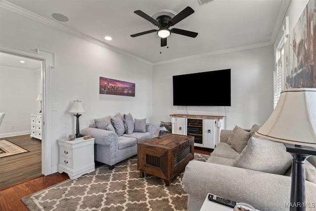 living room with ceiling fan, crown molding, and dark wood-type flooring