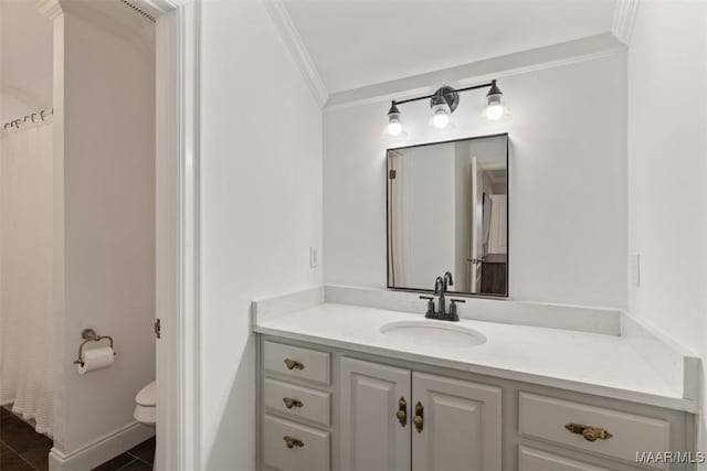 bathroom with vanity, toilet, and ornamental molding