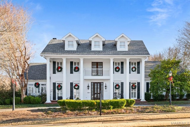 view of front of property with a balcony and french doors