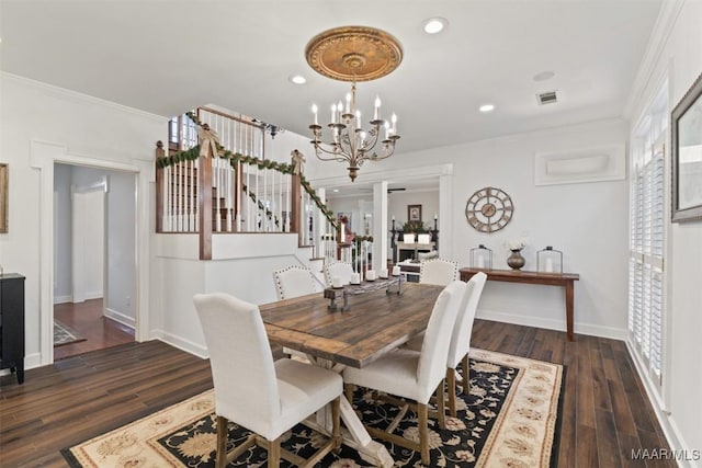 dining room with dark hardwood / wood-style flooring, ornamental molding, and a chandelier