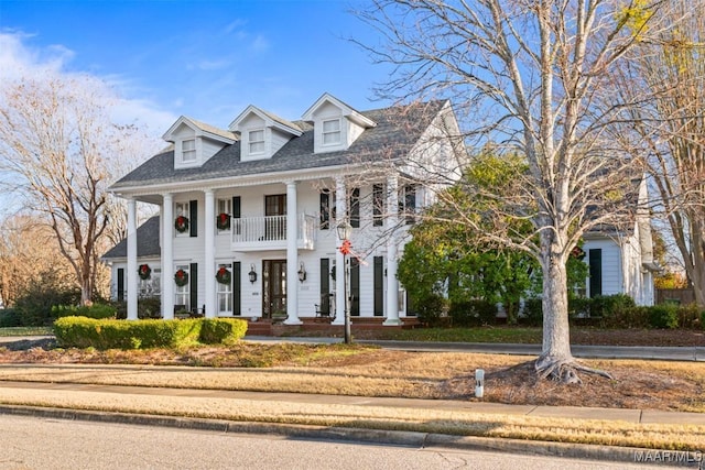 view of front of property with a balcony and covered porch