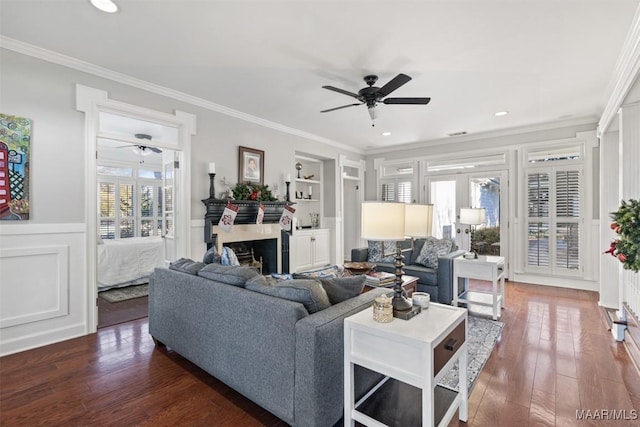 living room featuring crown molding, built in features, ceiling fan, and dark hardwood / wood-style floors