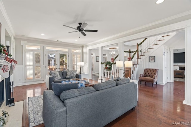 living room featuring crown molding, french doors, dark hardwood / wood-style floors, and ceiling fan with notable chandelier