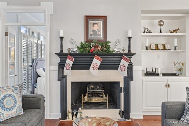 living room featuring hardwood / wood-style flooring and built in features