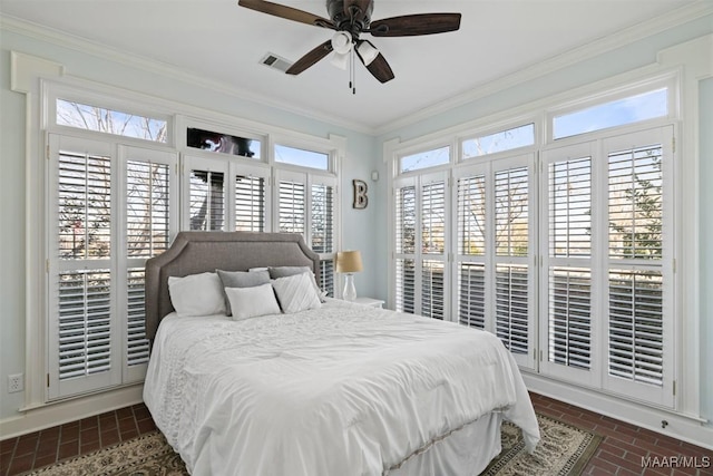 bedroom with ceiling fan and ornamental molding