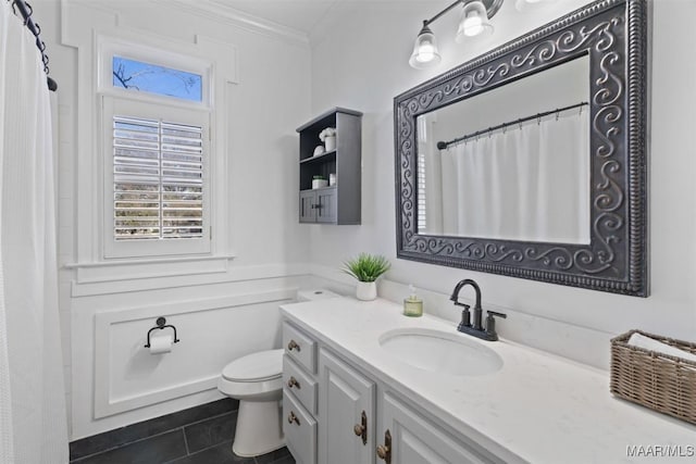 bathroom with tile patterned flooring, vanity, toilet, and ornamental molding