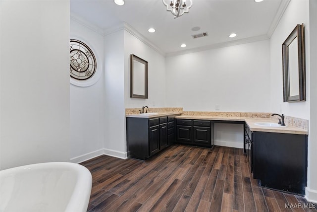 bathroom featuring crown molding, a washtub, vanity, and wood-type flooring