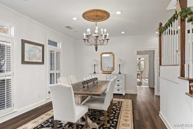 dining space featuring dark hardwood / wood-style flooring, an inviting chandelier, plenty of natural light, and ornamental molding