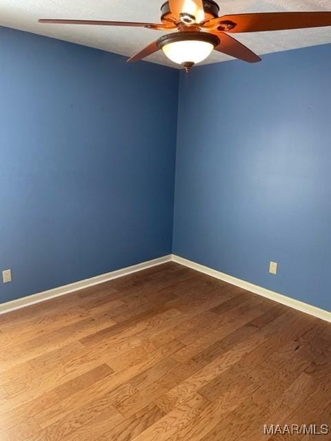 unfurnished room featuring ceiling fan, light hardwood / wood-style flooring, and a textured ceiling