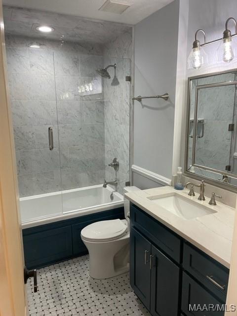 full bathroom featuring vanity, toilet, and tiled shower / bath