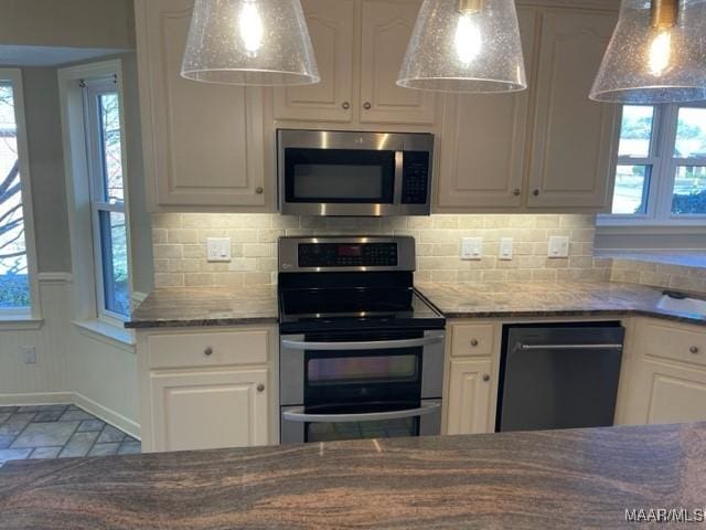 kitchen featuring backsplash, white cabinets, and stainless steel appliances