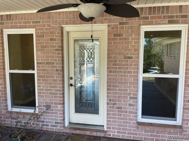 entrance to property featuring ceiling fan