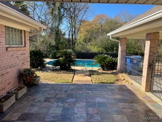 view of patio / terrace with a fenced in pool