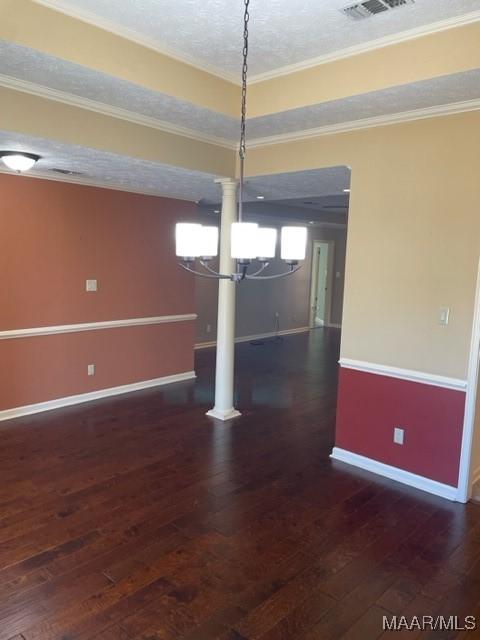 interior space with crown molding, dark wood-type flooring, a textured ceiling, and an inviting chandelier